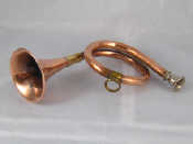 Appraisal: A copper hunting horn with brass mounts and plated mouthpiece