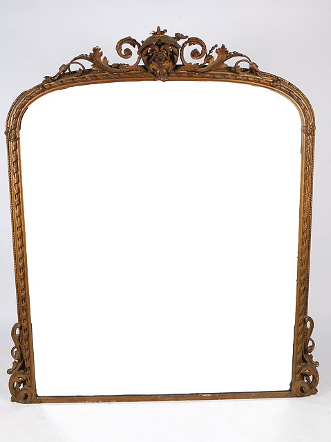 Appraisal: A VICTORIAN GILT FRAMED OVERMANTEL MIRROR with scrolling crest and