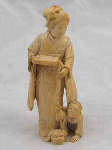 Appraisal: A Japanese carved ivory figure of mother and child approx