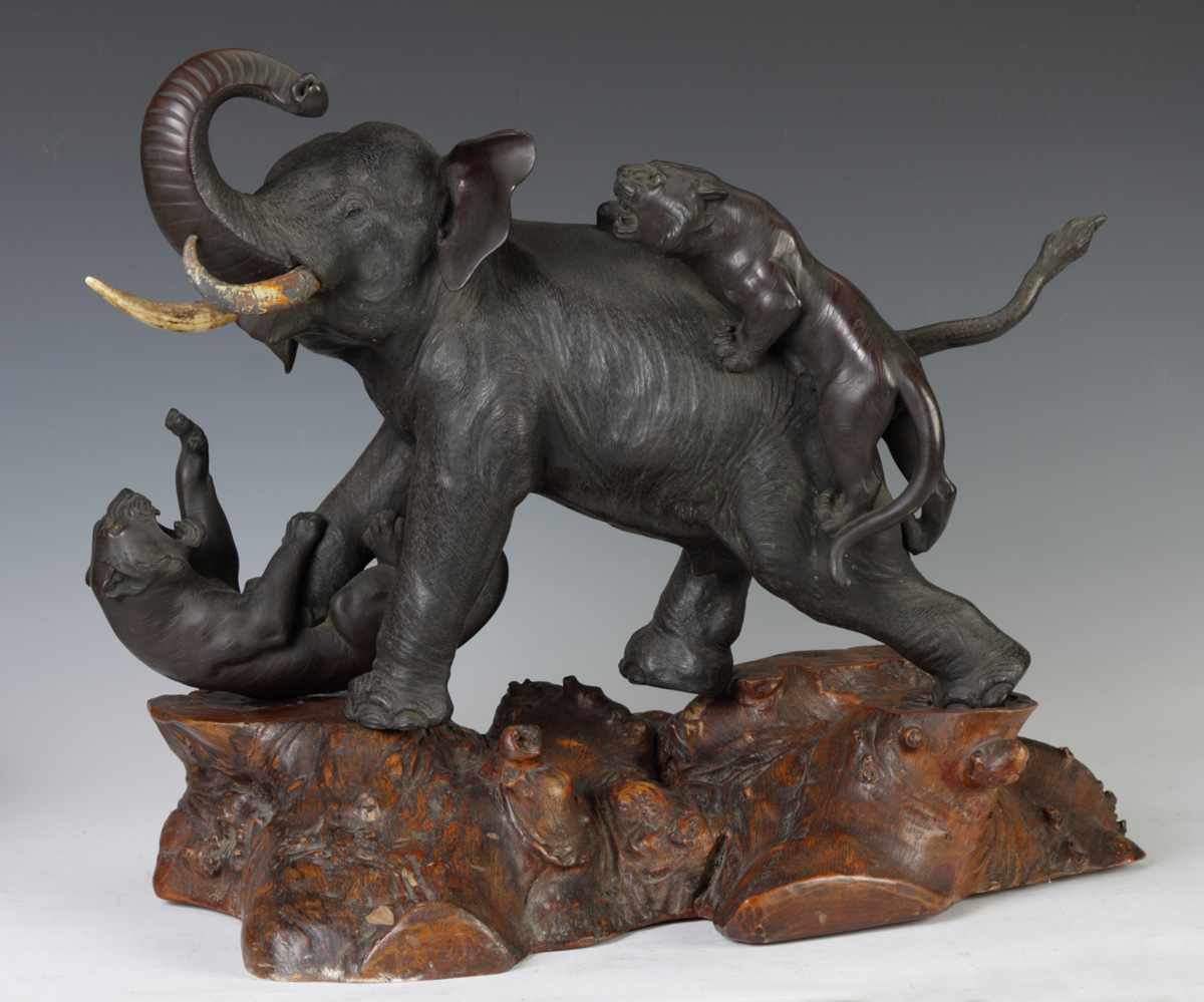 Appraisal: Sgn Japanese Bronze Elephant With attacking tigers On a carved