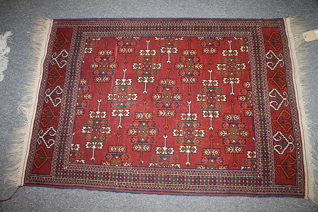 Appraisal: A BOKHARA TYPE RED GROUND RUG with elephant's foot designs