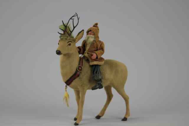 Appraisal: SANTA RIDING REINDEER CANDY CONTAINER Germany one of the most