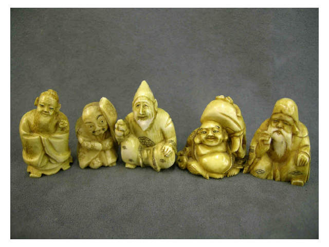 Appraisal: Five ivory netsuke including man in cloak with staff white