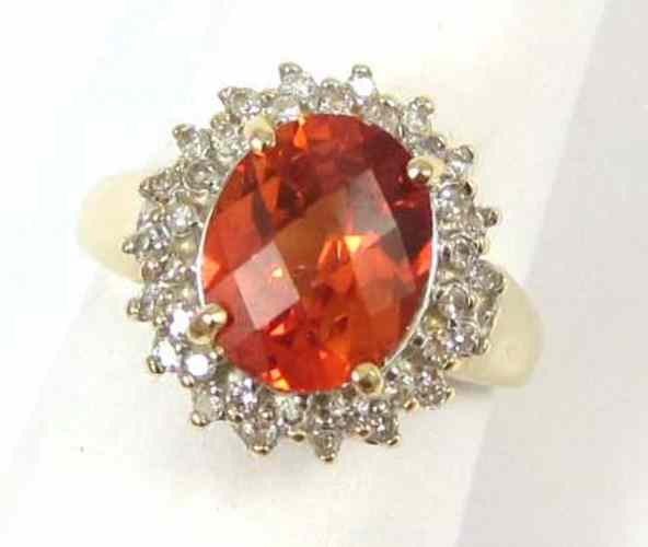 Appraisal: ORANGE SAPPHIRE AND DIAMOND RING k yellow gold set with