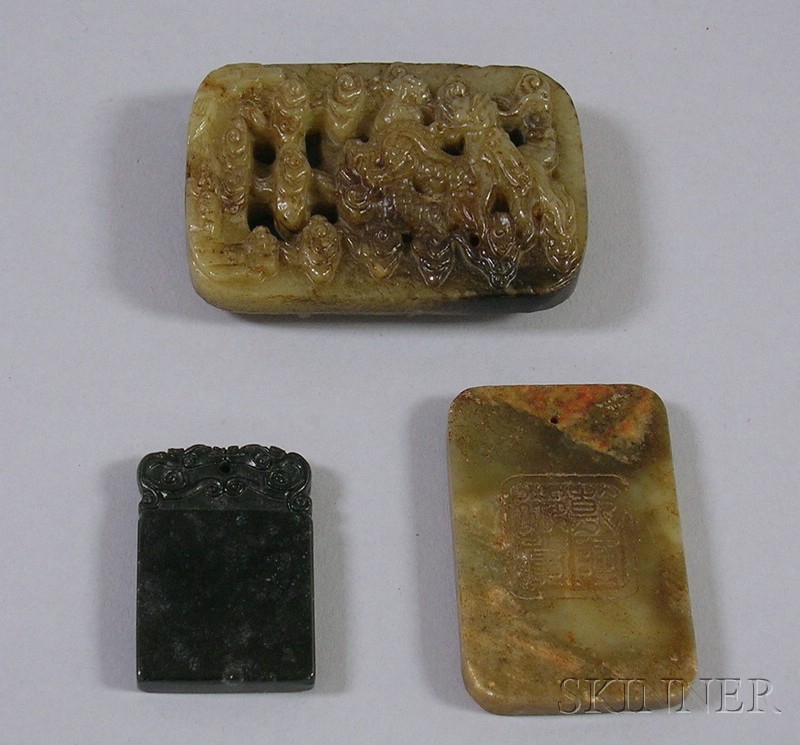 Appraisal: Three Jade Stone Carved Pendants a garden scene a carved