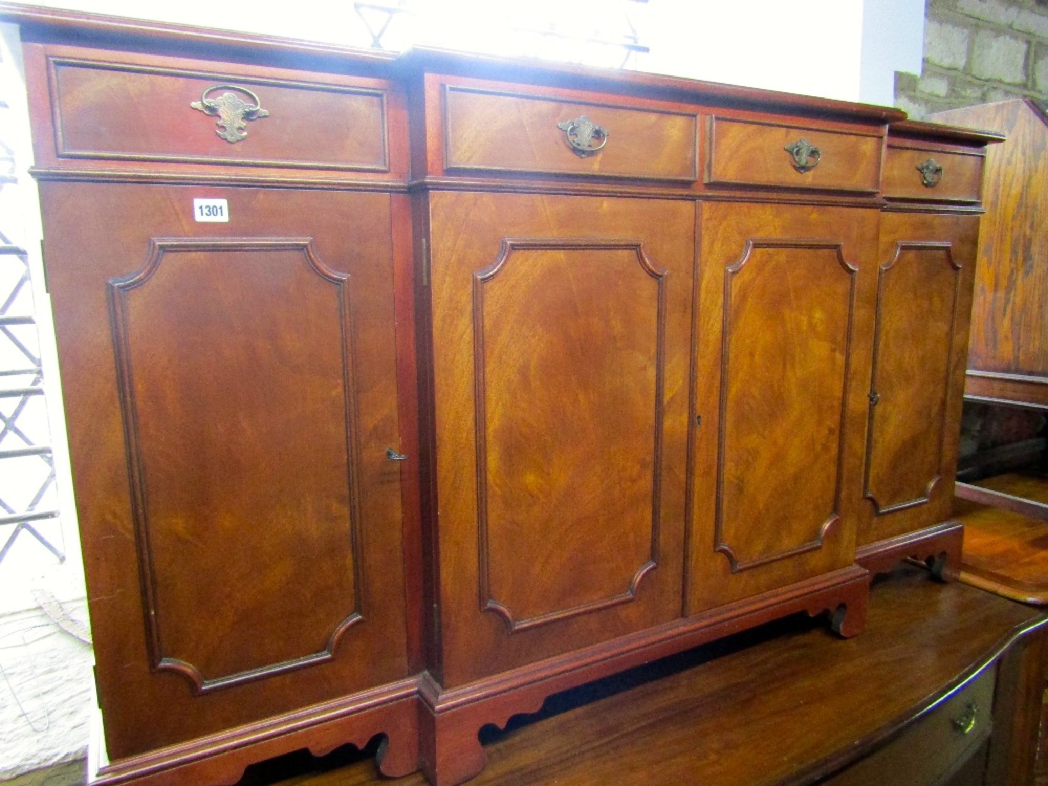 Appraisal: A reproduction mahogany shallow breakfront sideboard in the Georgian style