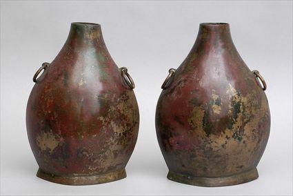 Appraisal: PAIR OF HAN MOTTLED BRONZE FISH VASES Of pointed flattened