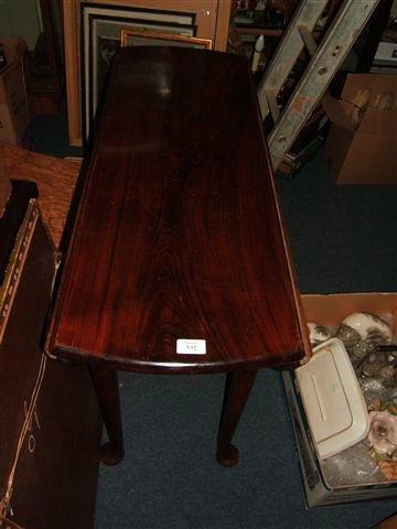 Appraisal: A George III style mahogany oval drop leaf dining table