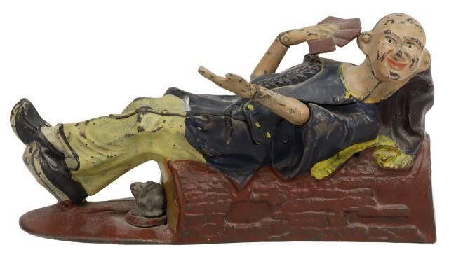 Appraisal: Cast iron bank Reclining Chinaman Holding Playing Cards mfg by