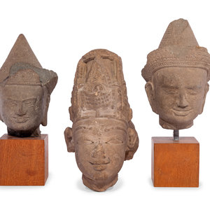 Appraisal: Three Carved Stone Heads of Buddha comprising two Khmer examples