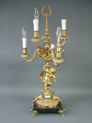 Appraisal: A Continental gilt metal six branch candelabrum on a cherub