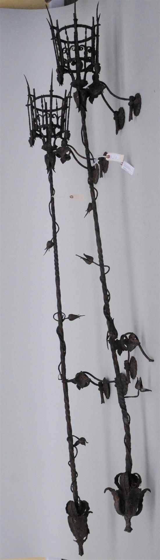 Appraisal: PAIR IRON WALL TORCHIERES Iron with floral and vine motifs