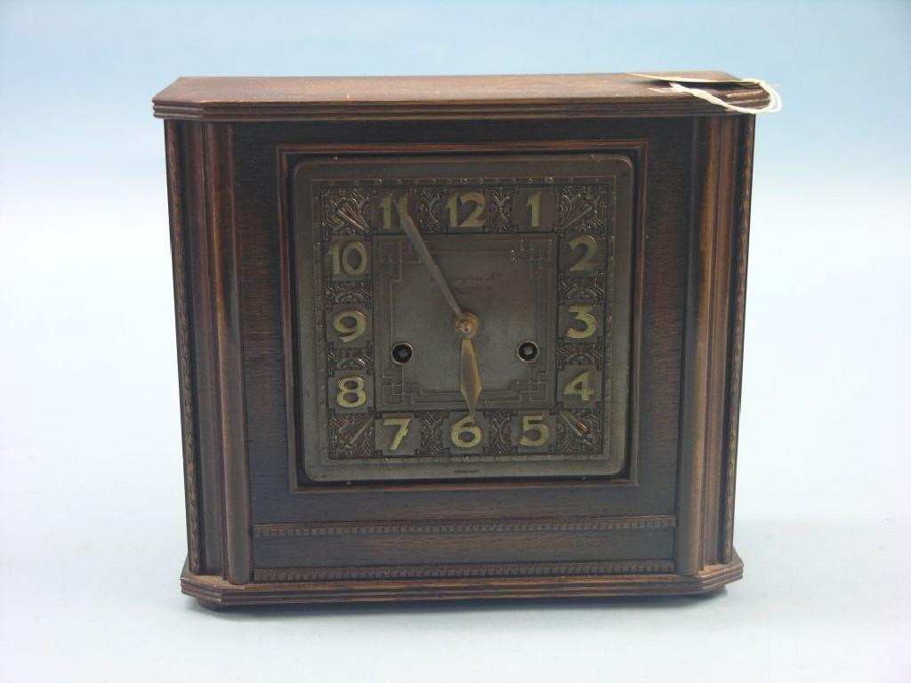 Appraisal: A dark oak veneered mantel clock featuring square dial and