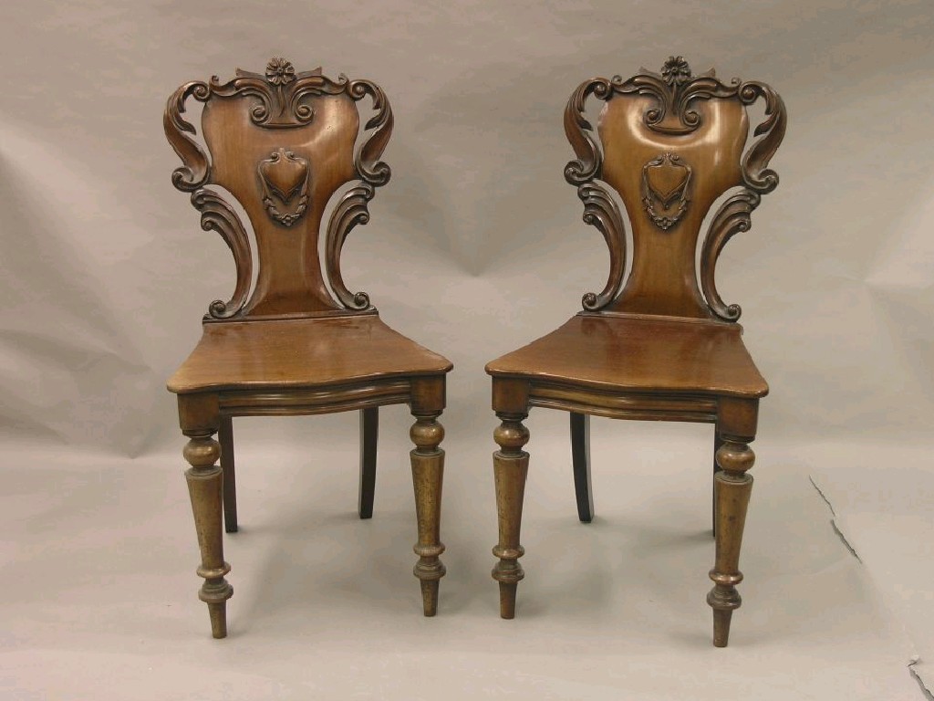 Appraisal: A good pair of Victorian mahogany hall chairs the backs