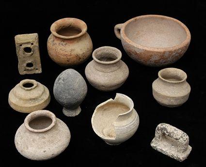 Appraisal: Nine Persian Terracotta Vessels together with a Pestle