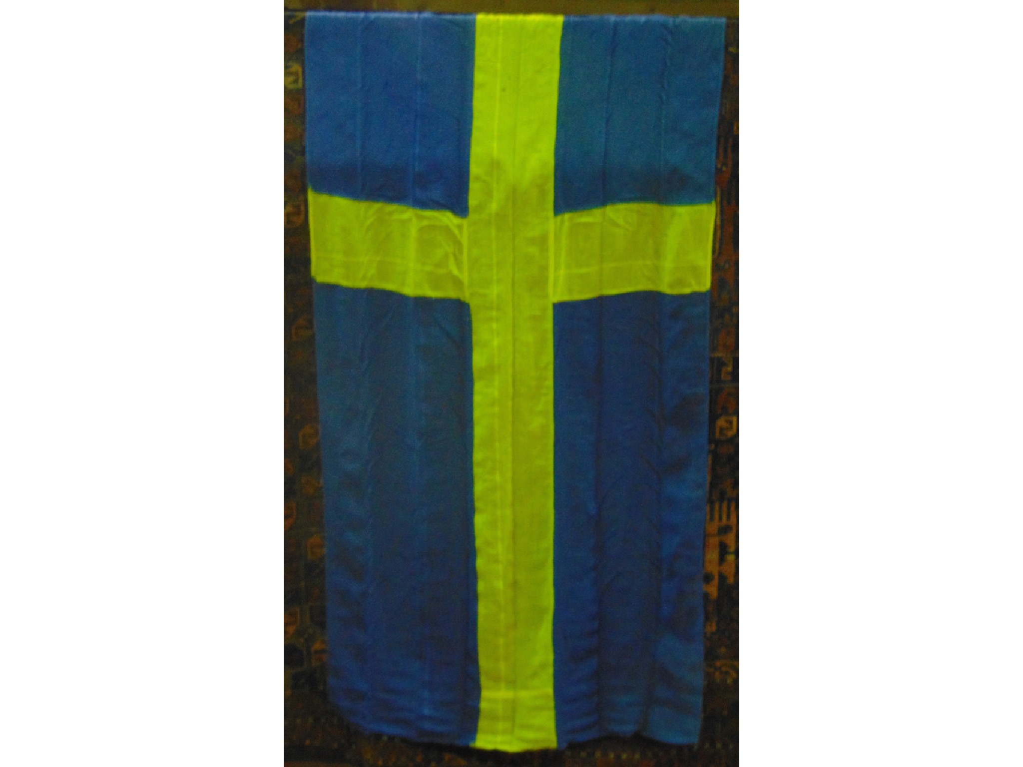 Appraisal: A large vintage Swedish flag suspended on a polish timber