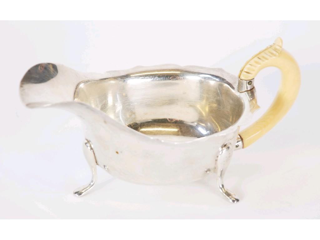 Appraisal: GEORGE VI SILVER SAUCE BOAT with carved ivory handle by