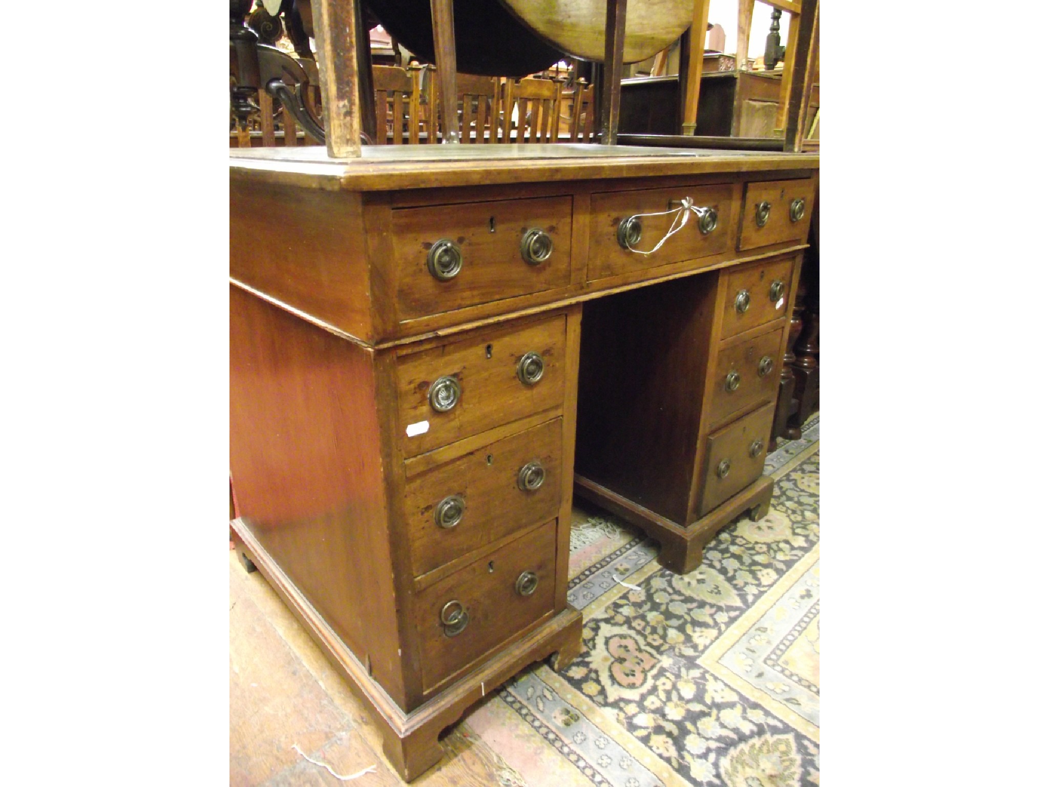 Appraisal: A small th century mahogany kneehole writing desk fitted with