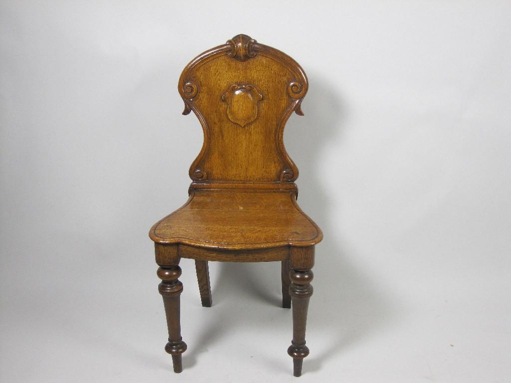 Appraisal: A Victorian oak Hall Chair carved shield to back