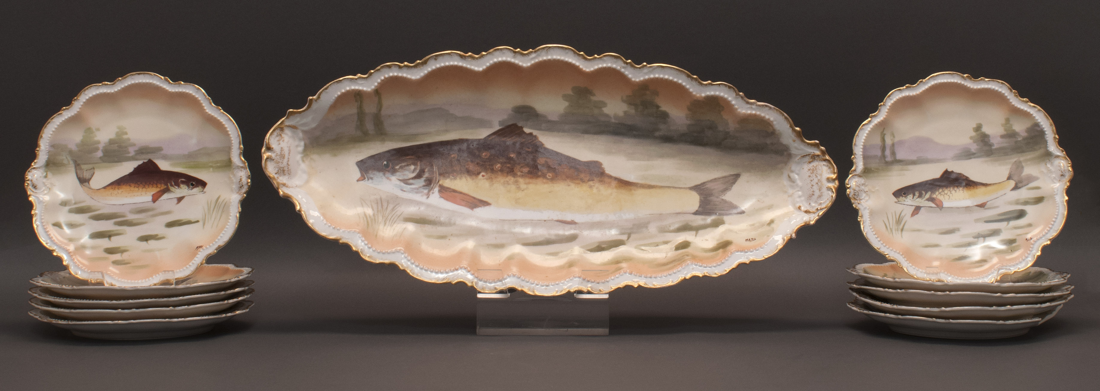 Appraisal: LIMOGES FISH SERVICE Early th CenturyWith hand-painted fish and foliate