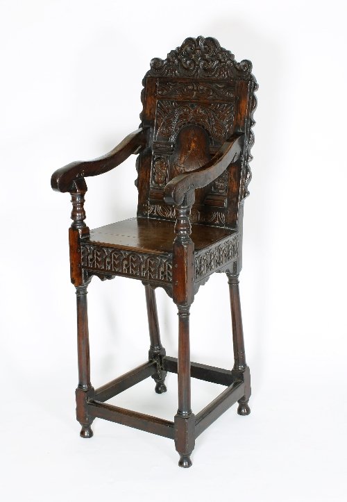 Appraisal: A th Century child's panel back high chair with carved