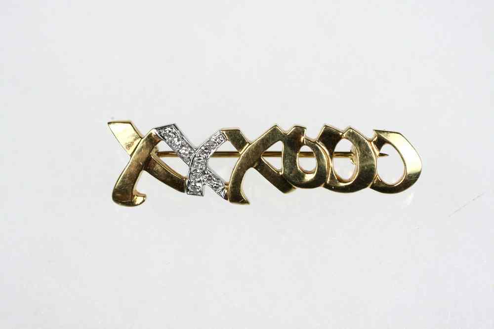 Appraisal: BROOCH - Bar form brooch with X's and O's with