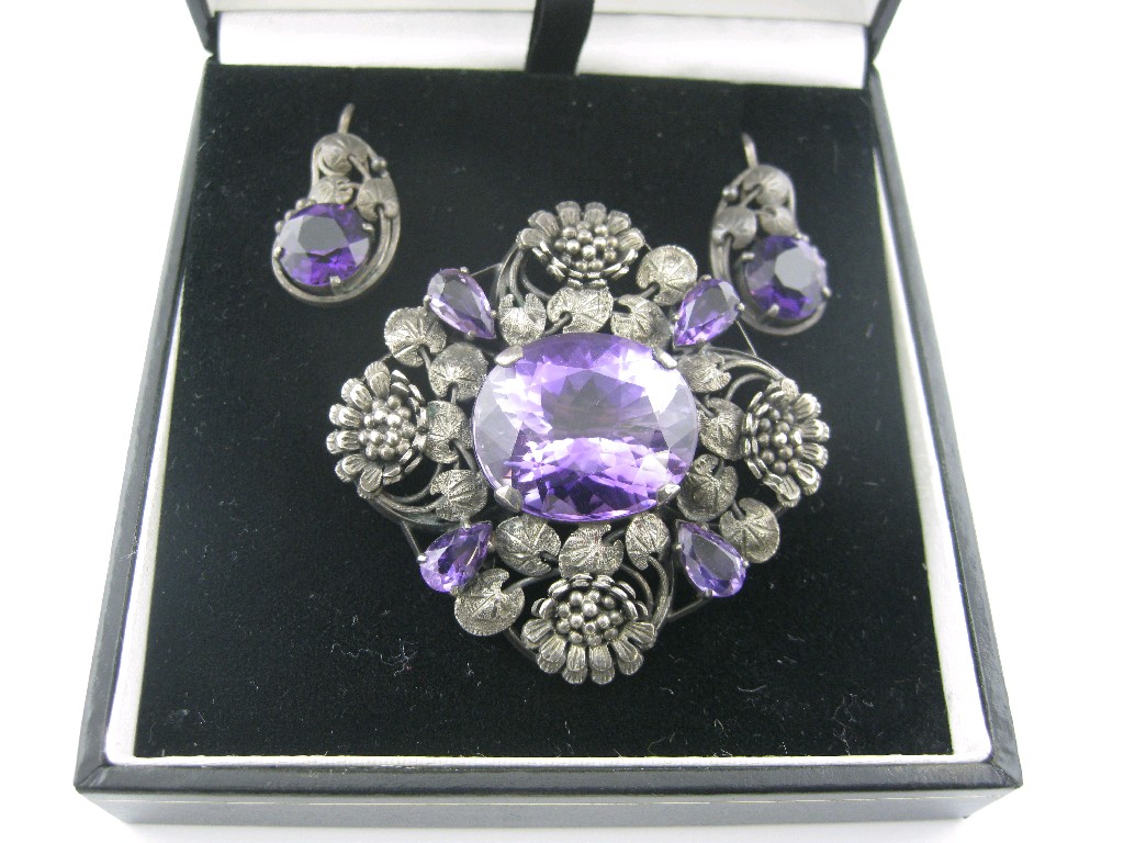 Appraisal: A Continental Pendant Brooch embossed flowers set purple stone a