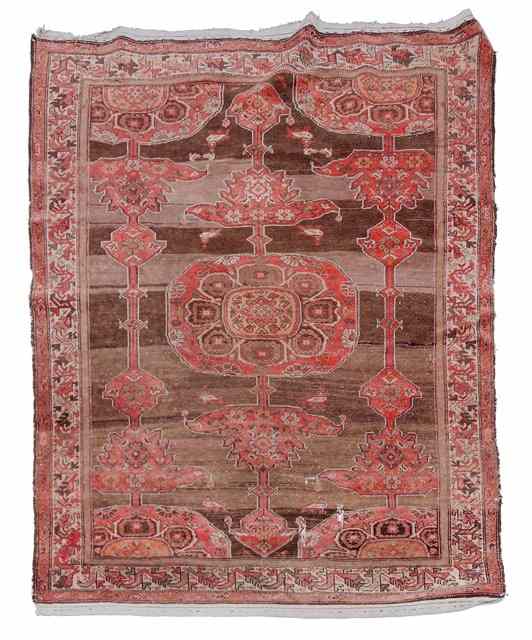 Appraisal: A PERSIAN MALAYER brown ground rug decorated linked medallion within