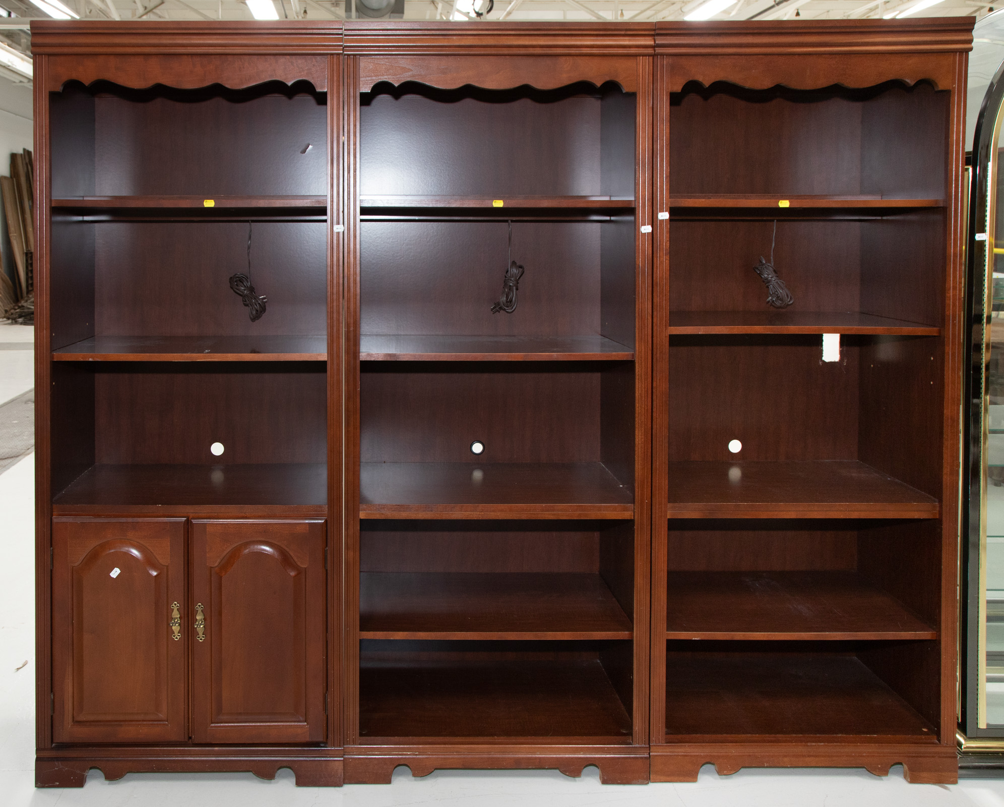 Appraisal: THREE TRADITIONAL STYLE CHERRY BOOKCASES Contemporary one with cabinet base