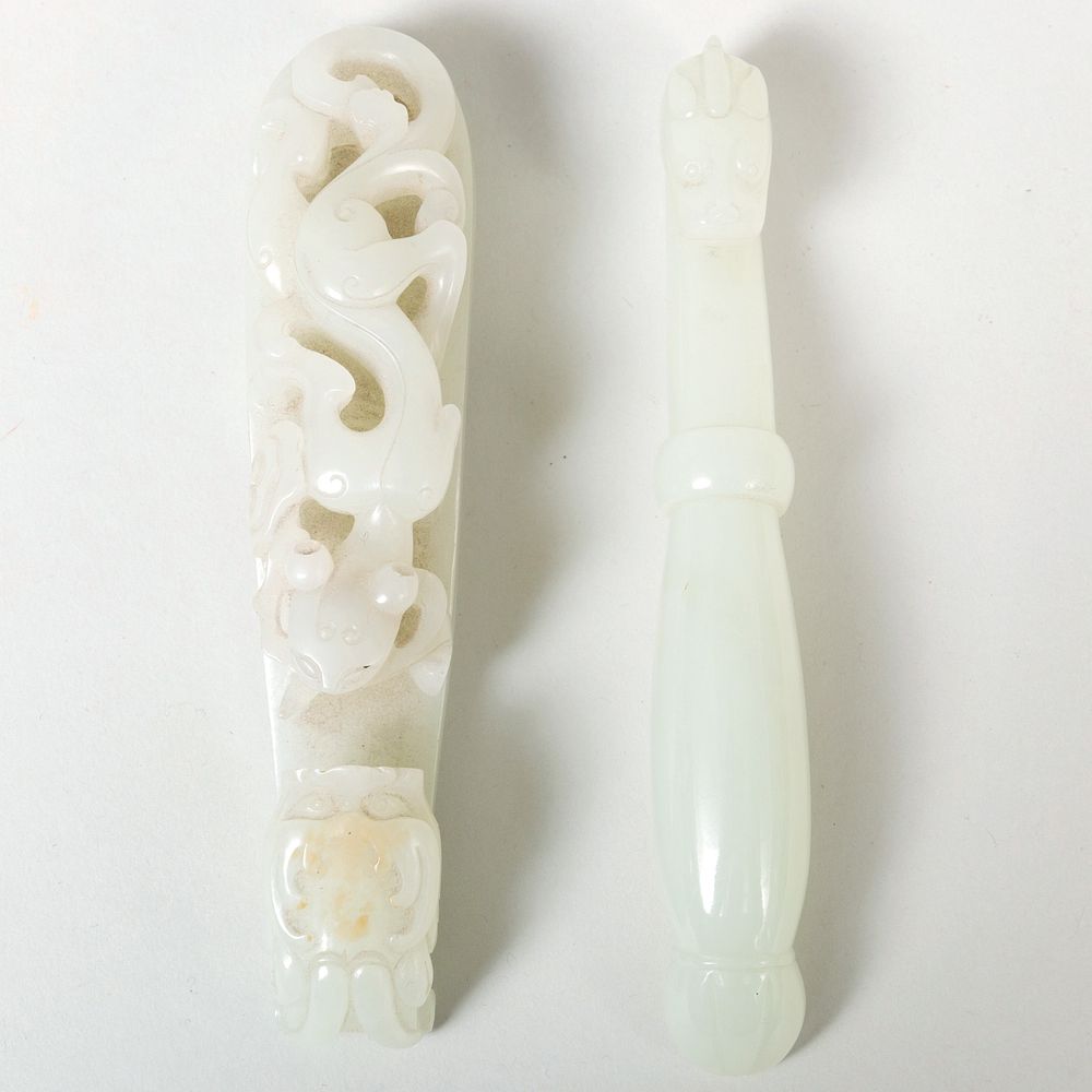 Appraisal: Two Chinese Jade Robe Hooks in long Condition Natural inclusions