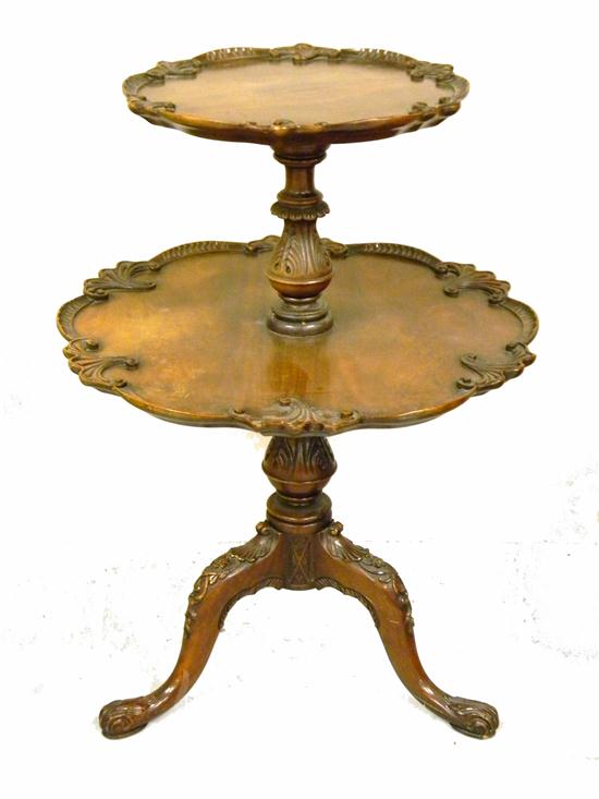 Appraisal: Georgian style two tier stand carved scalloped edges carved standard