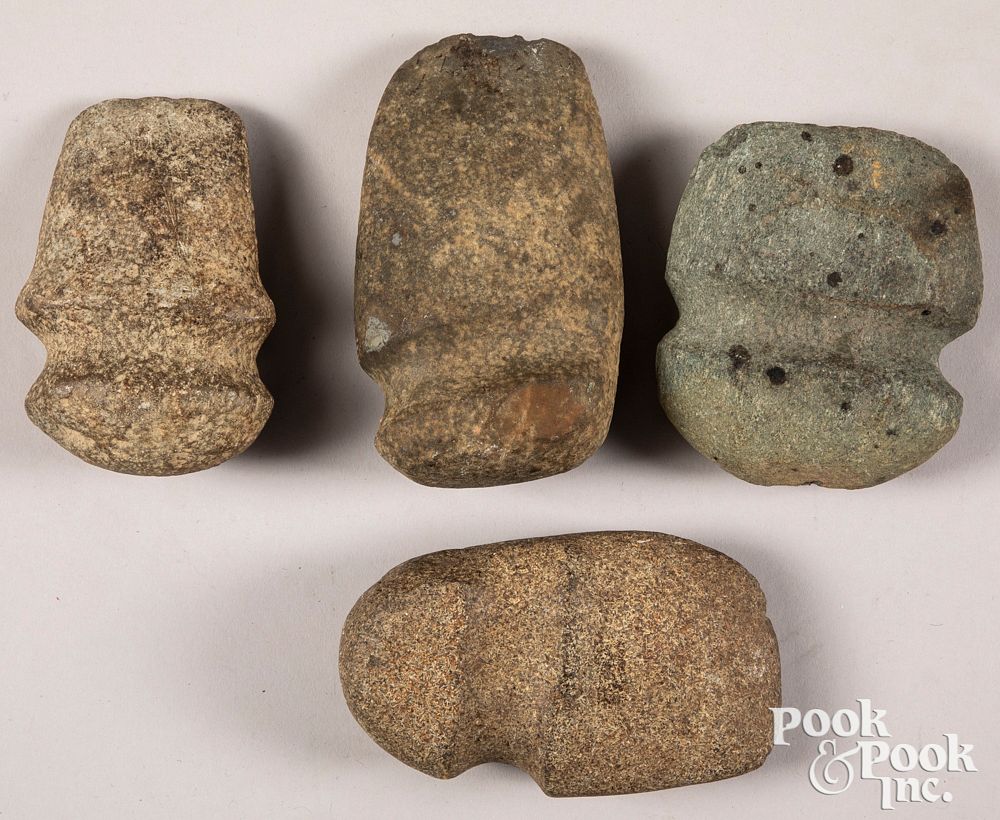 Appraisal: Four ancient stone axe heads Four ancient stone axe heads