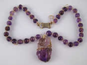 Appraisal: A Chinese amethyst and rock crystal bead necklace with a