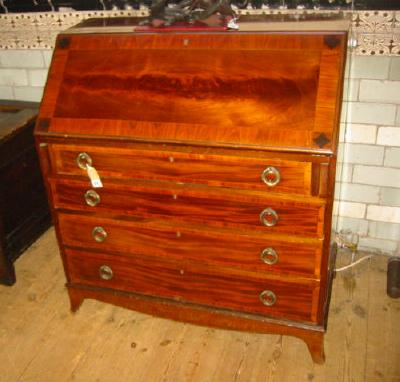 Appraisal: A MAHOGANY BUREAU crossbanded with stringing the fall front with