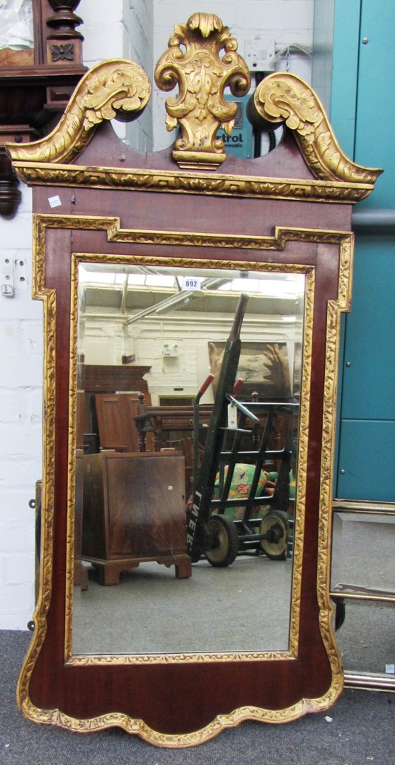 Appraisal: A George III style parcel gilt mahogany wall mirror with