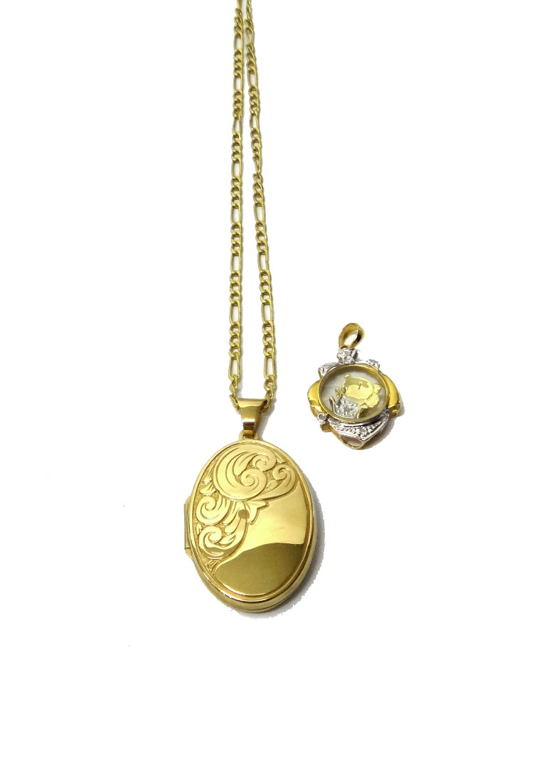 Appraisal: A gold and diamond set pendant glazed to the centre