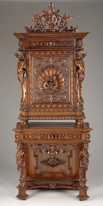 Appraisal: LAVISHLY CARVED TWO PIECE WALNUT CABINET Top cabinet having one