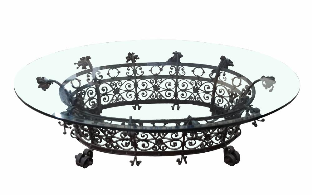 Appraisal: IRON GLASS COFFEE TABLEthe oval top with beveled edge inches