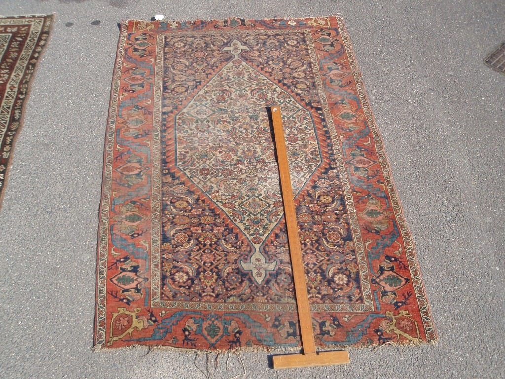 Appraisal: An early th century Persian red ground rug cm x