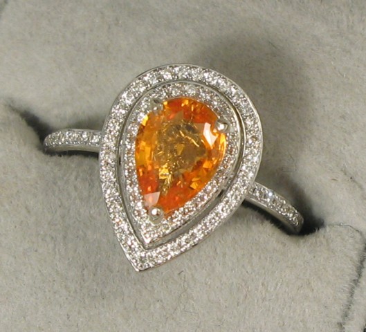 Appraisal: ORANGE SAPPHIRE DIAMOND AND WHITE GOLD RING The k white