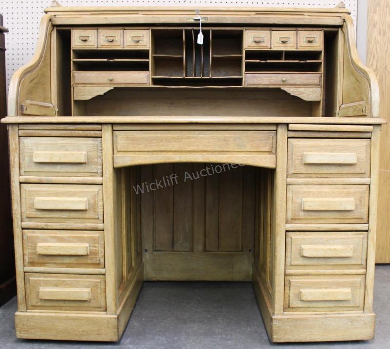 Appraisal: An antique oak roll-top desk with S-roll by Angus of