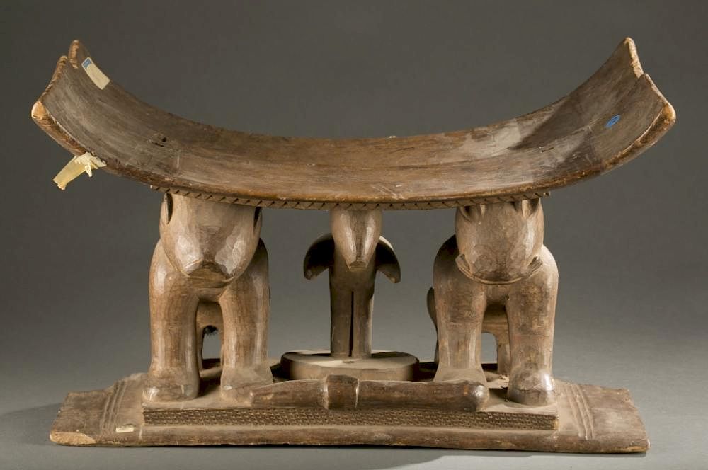 Appraisal: Ghanese stool th century A stool with two crouching felines