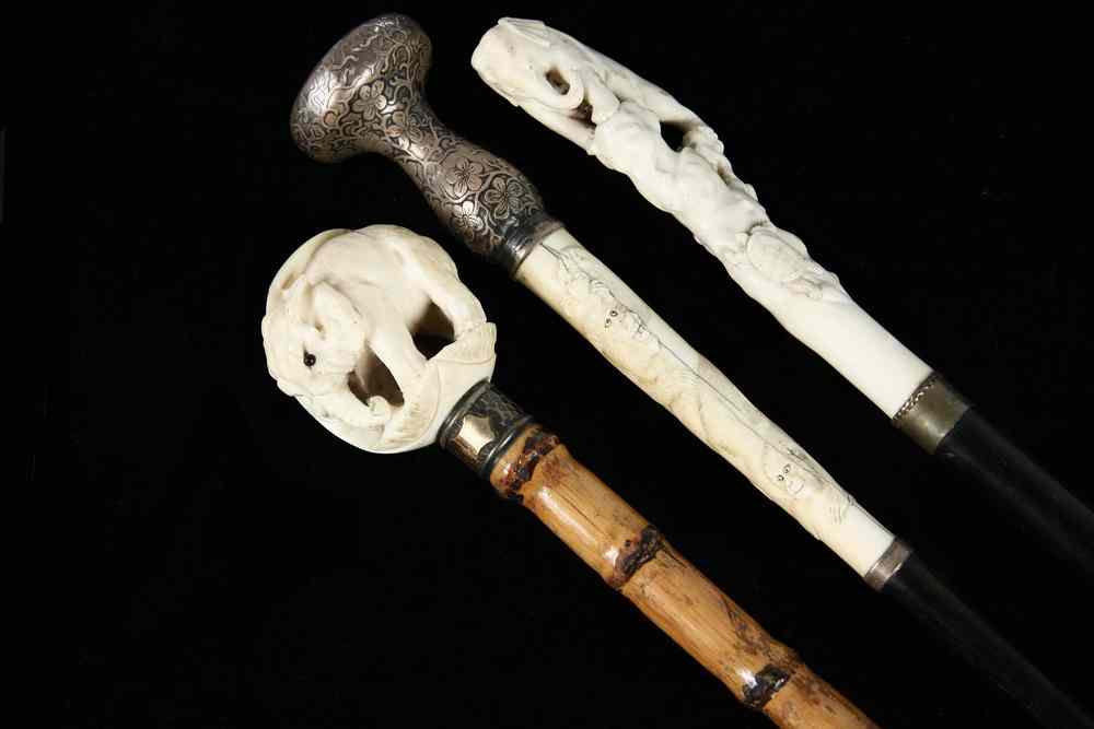 Appraisal: JAPANESE CARVED IVORY TOP CANES - Including Ebony stick with