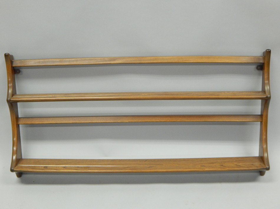 Appraisal: An Ercol type elm plate rack with two shelves on