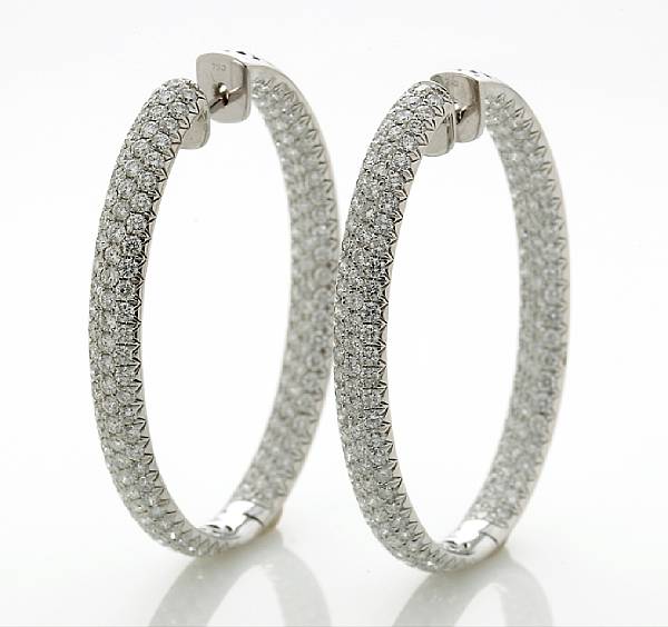 Appraisal: A pair of diamond oval-shaped hoop earrings estimated total diamond