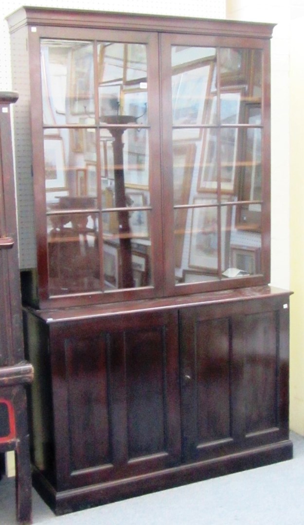 Appraisal: A late th century mahogany bookcase cupboard with pair of