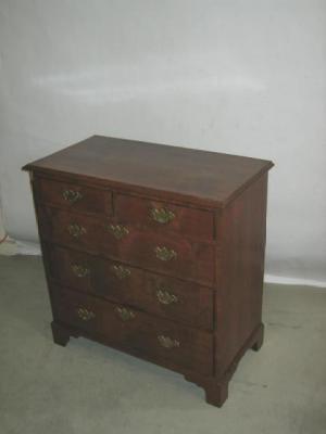 Appraisal: A WALNUT CHEST with moulded edged top two short over