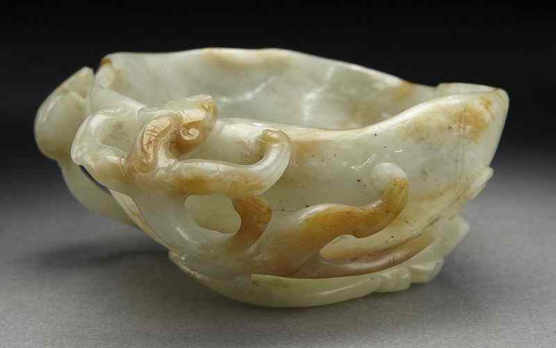 Appraisal: Chinese Ming carved jade cupdepicting chi dragons and lotus ''H