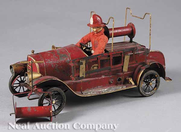 Appraisal: A French Mechanical Toy Fire Engine with Fireman and Accessories