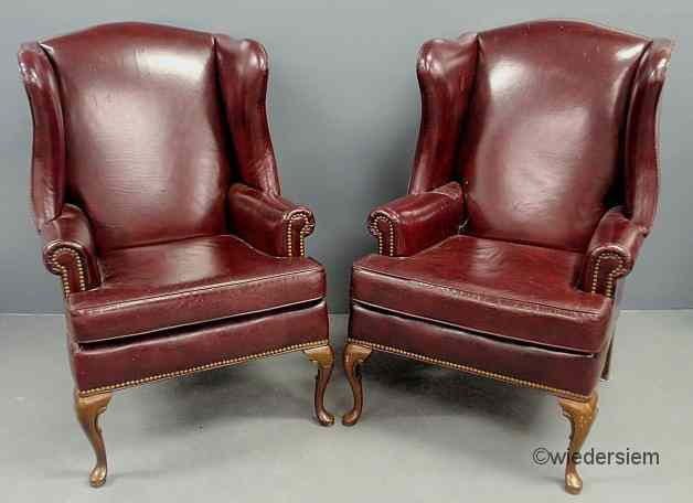 Appraisal: Pair of Queen Anne style red leather wing chairs ''h